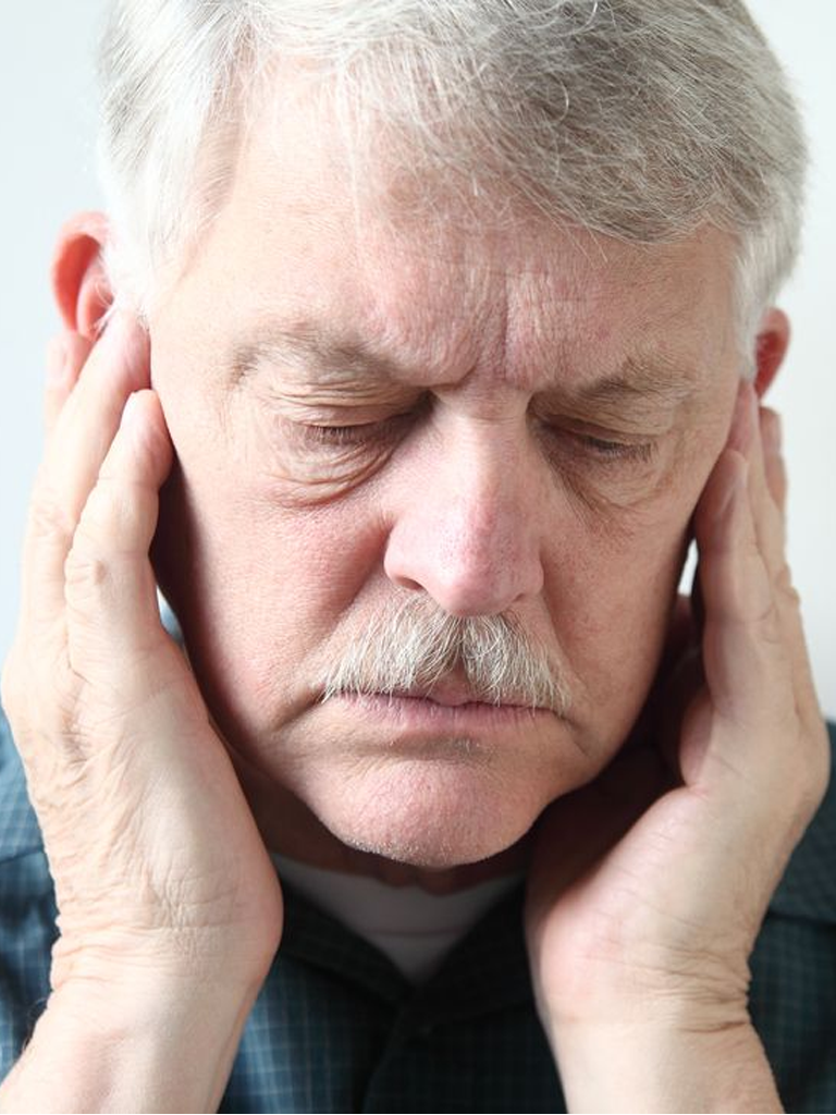 Patient experiencing TMJ disorder symptoms being diagnosed at Sukriti Hospital in Bharuch. Dr. Vihang Sukhadia specializing in comprehensive TMJ disorder diagnosis and treatment.